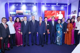 苏林总书记与各位党和国家领导人在越南通讯社展区合影留念。图自 越通社