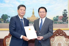 越南驻琅勃拉邦总领事武玉李(左)与老挝外交部副部长阿努帕布·翁诺克欧。图自越通社