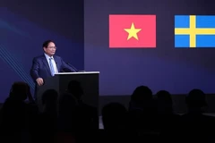 政府总理范明政在论坛上发言。图自越通社