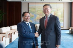 范明政会见上海市委书记陈吉宁。图自越通社