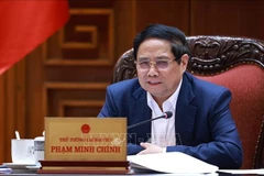 越南政府总理范明政主持召开政府常务委员会与各部委和地方会议。图自越通社