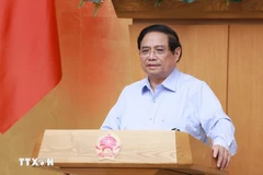 政府总理范明政在会议上发言。图自越通社