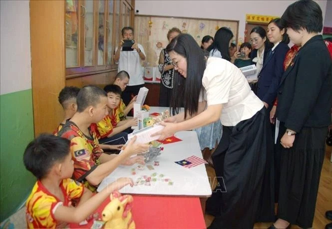 总理夫人黎氏碧瓒前往位于吉隆坡的晶阳儿童福利中心（Jing Sun）进行探访。图自越通社