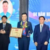 越共中央政治局委员、中央书记处书记、中央宣教与民运部部长阮仲义与越南国会文化教育委员会主任阮德荣为李自仲奖获奖者颁奖。胡志明共青团中央委员会供图