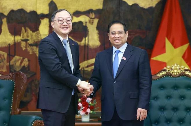 越南政府总理范明政会见了中国电力建设集团亚太地区事务董事长周嘉义。图自越通社 vna-potal-thu-tuong-chu-tich-khu-vuc-chau-a-thai-binh-duong-cua-tap-doan-xay-dung-dien-luc-trung-quoc-8044847.jpg