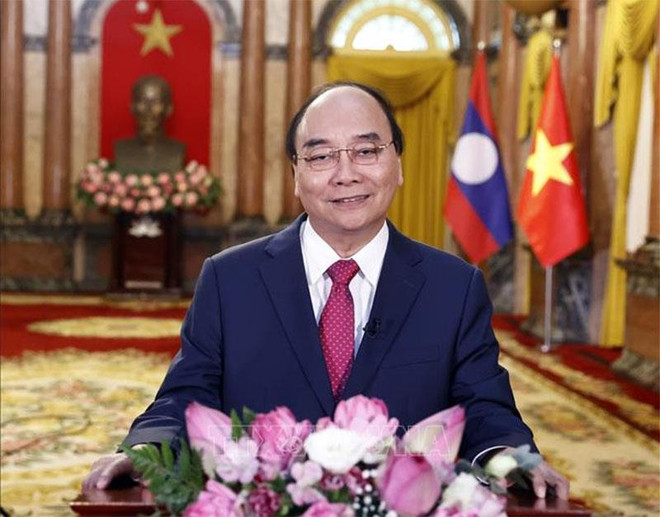 越南国家主席阮春福:越老关系将不断深入发展、开花结果 ảnh 1 越南国家主席阮春福:越老关系将不断深入发展、开花结果 ảnh 1