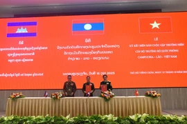 越老柬三国国防部长年度会晤会议纪要签署仪式。图自越通社