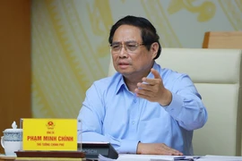 政府总理范明政在会议上发言。图自越通社