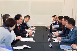 双方会晤现场。图自越通社