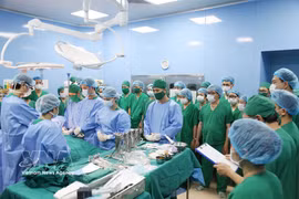 医护人员和专家在手术前向这位19岁器官捐献者及其家人低头默哀，表达由衷的感谢。图自越通社