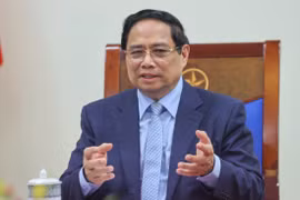 越南政府总理范明政与德国总理弗里德里希·默茨通电话。图自越通社