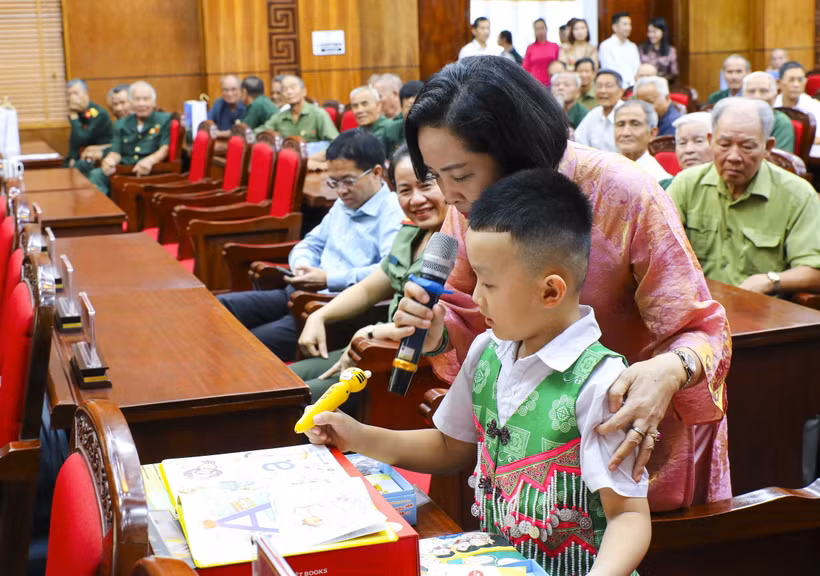 国会副主席阮氏清向小学生赠送礼物并指导使用英语点读笔。图自越通社