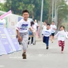 儿童积极参加跑步活动 图自越通社