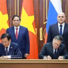 越南政府总理范明政与俄罗斯联邦政府总理米哈伊尔·米舒斯京共同见证在越南境内建设核电站合作协议的签署仪式。 图自越通社