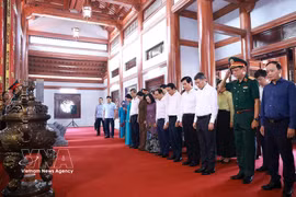 在庄严肃穆、虔诚感恩的氛围中，黎明兴和工作代表团默哀一分钟，缅怀长眠于谅山省烈士陵园的英雄烈士们——他们为祖国的独立、自由和人民的幸福奉献了青春和热血。图自越通社