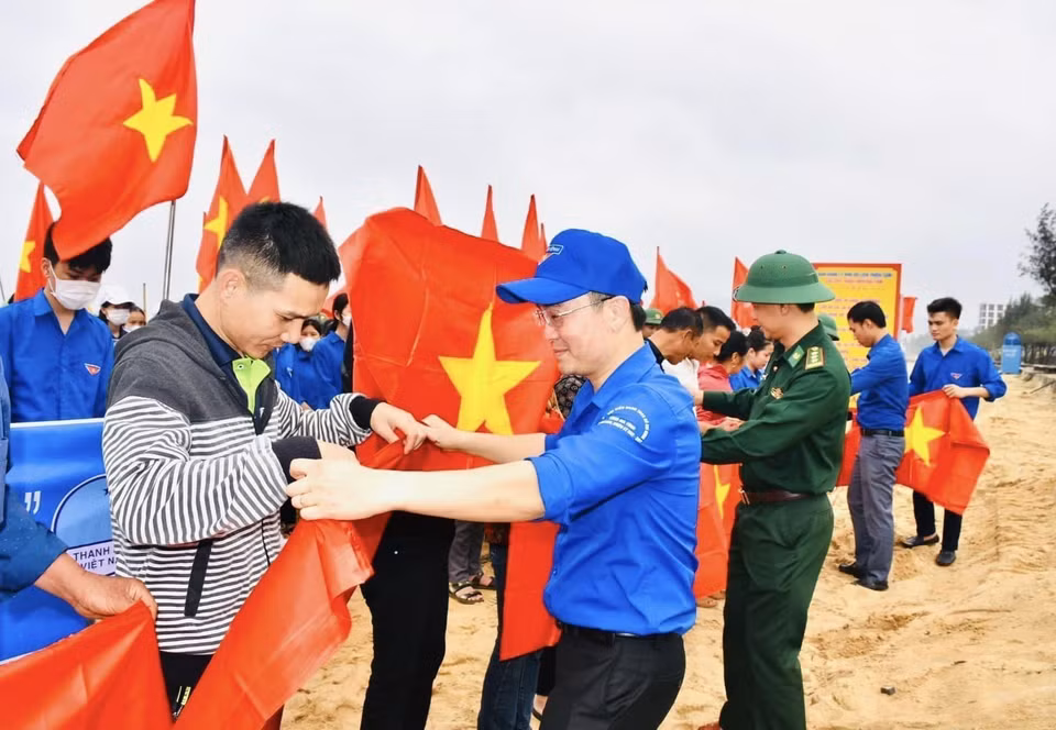 河静省职能力量向当地渔民赠送国旗，鼓舞渔民们坚持靠海谋生。图自 越通社