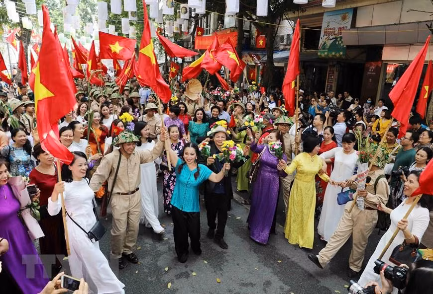 首都人民兴高采烈迎接凯旋归来的军团场景再现。越通社记者 日英 摄