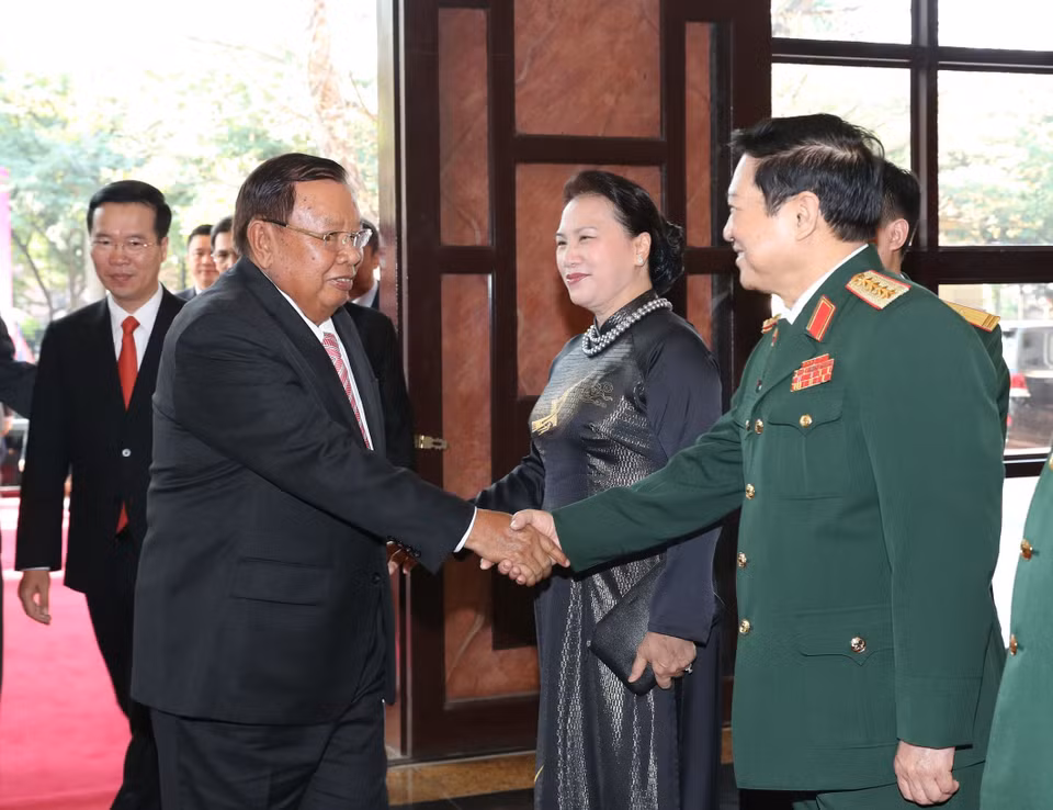 越南国防部长吴春历大将与老挝人民革命党共产党中央总书记、国家主席本扬•沃拉吉握手。越通社记者仲德 摄