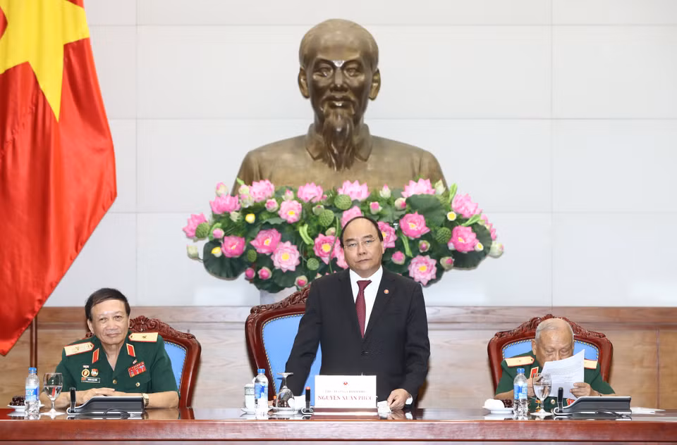 阮春福与长山—胡志明大道传统协会代表交流。（图片来源：越通社）