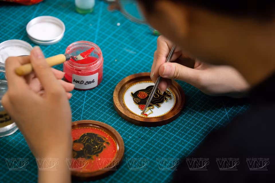 当图案框架做好之后，工匠们开始将沙子涂上不同的颜色。图自越南画报