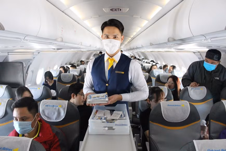 空姐在飞机上为乘客送餐。图片来源：越通社Vietnam+