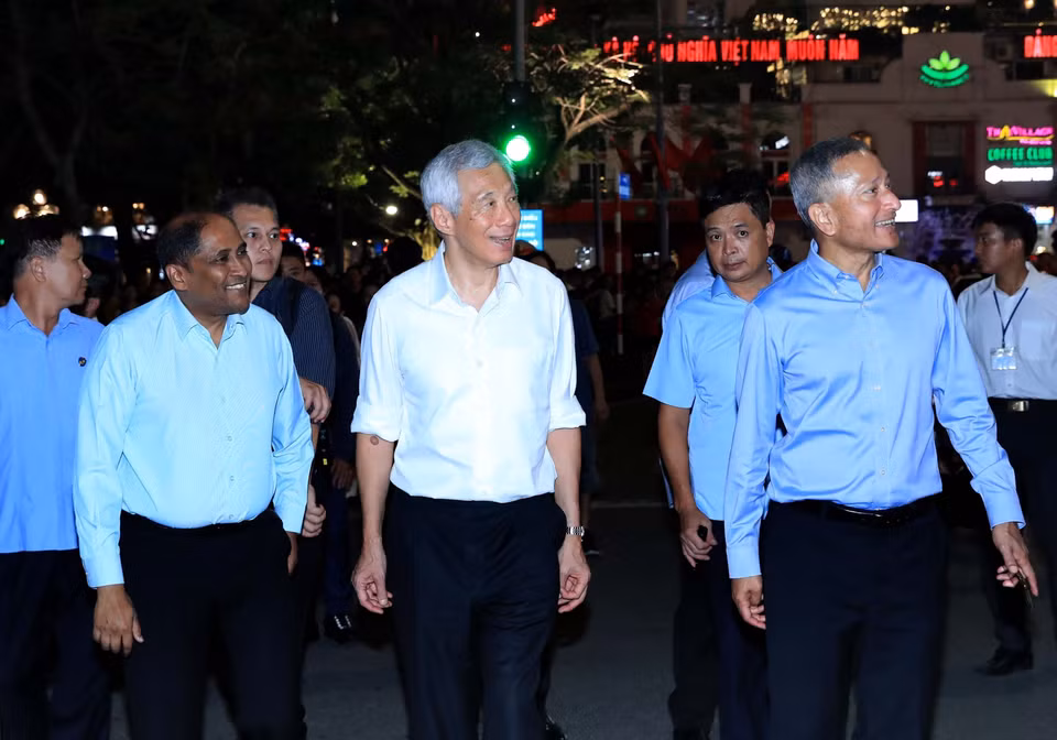 新加坡总理李显龙漫步在还剑湖畔。图自越通社