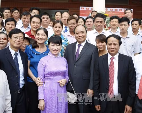 阮春福总理与选民们合影。（图片来源：越通社）