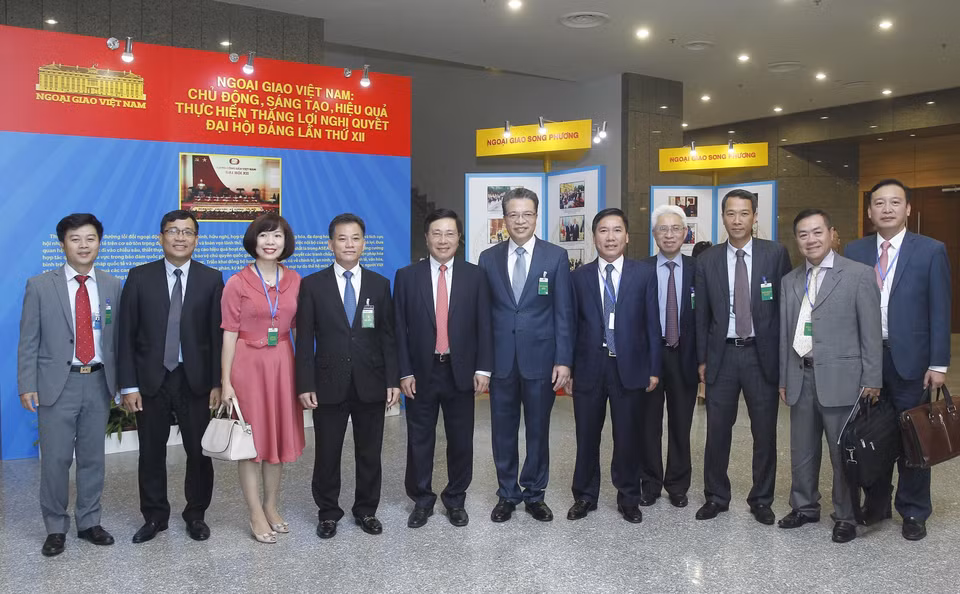 越南政府副总理兼外长范平明与参会代表合影。越通社记者 林庆 摄