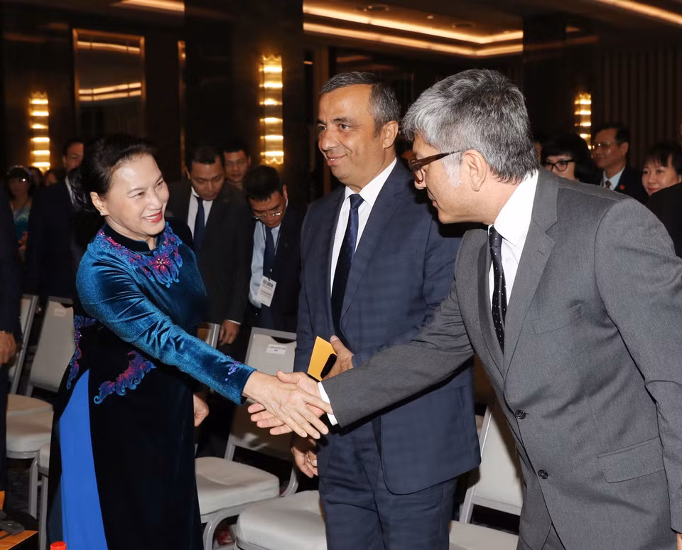 阮氏金银同与会代表亲切握手。越通社记者 仲德 摄