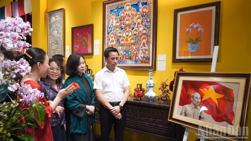 各位代表欣赏胡志明主席的刺绣肖像作品。图自nhandan.vn