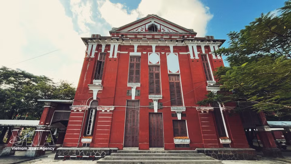 这所学校具有鲜明的印度支那建筑风格，红色外墙沉稳温暖，拱形门窗、宽敞的走廊与造型协调雅致的瓦顶相映成趣，充分展现了西方建筑风格与越南本土建筑元素交融的独特魅力。图自 越通社