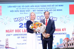 胡志明市越美友好协会主席阮文寿向美国驻胡志明市总领事梅丽莎·布朗赠送鲜花。图自越通社