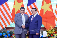 越南政府总理范明政（右）与马来西亚国会下议院议长佐哈里。图自越通社