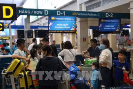 旅游在新山一国际机场办理手续。图自越通社
