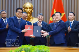 黎明兴总理见证PETRONAS与Petrovietnam之间《战略联盟协议》交换仪式。图自越通社