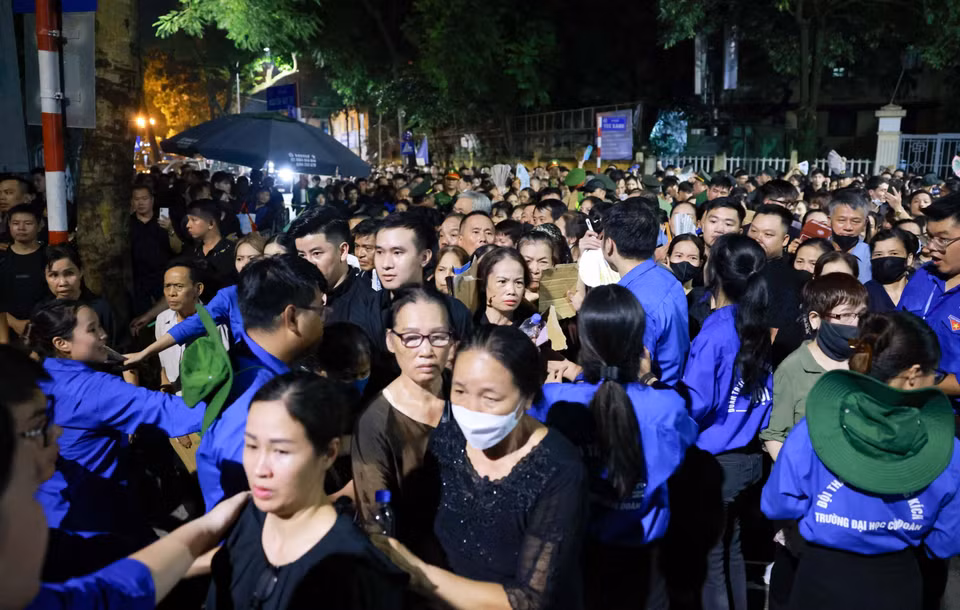 国家殡仪馆周围的街道上挤满了排队的人流。人民群众耐心等候吊唁阮富仲总书记。 图自越通社