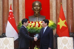 越南国家主席梁强会见新加坡总理黄循财。图自越通社
