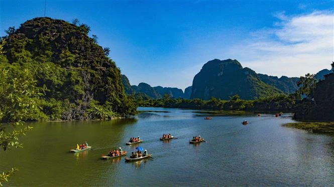 游客欣赏长安生态旅游区风景，探索神秘的洞穴。图片来源：越通社