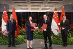 新加坡金融管理局（MAS）和越南国家证券委员会合作议定书交换仪式。图自越通社