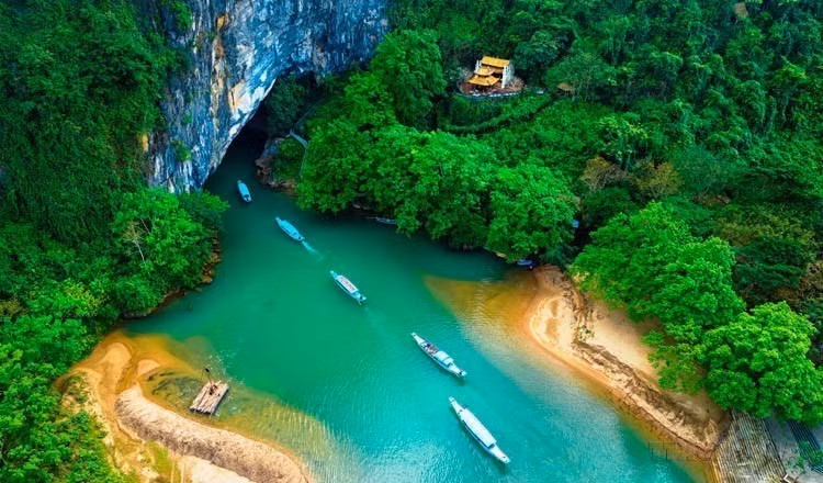 峰衙－几榜旅游码头的旅游船承载游客进入峰衙洞参观。图自越通社