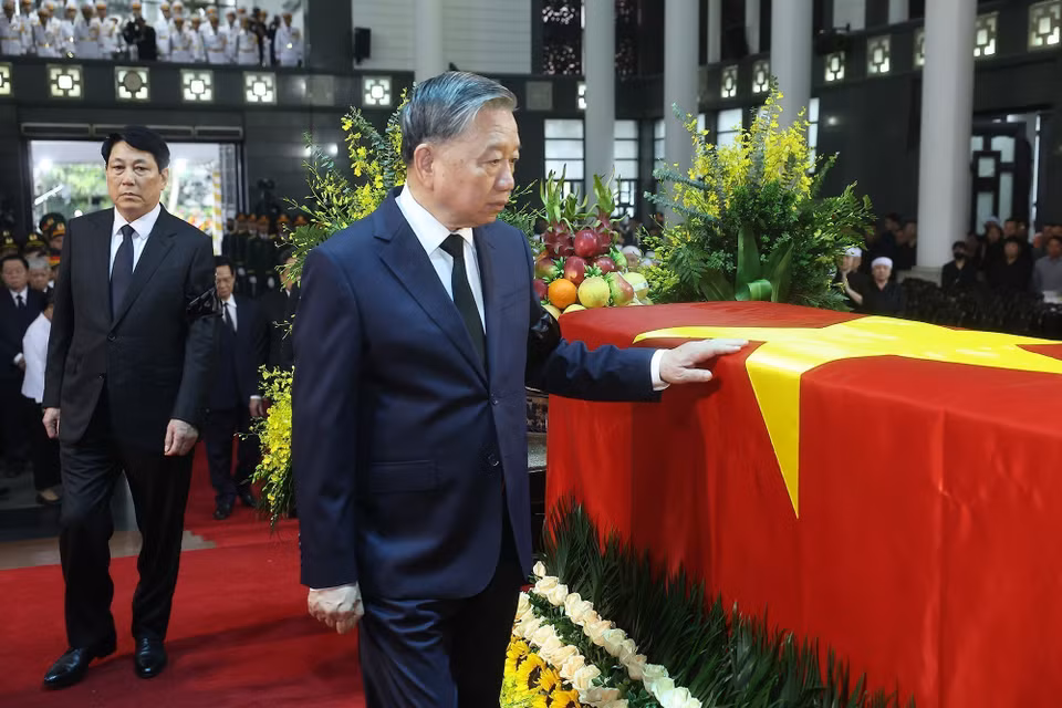 苏林总书记、梁强主席和代表们最后一次绕灵柩行礼，送别原越南国家主席陈德良。图自越通社