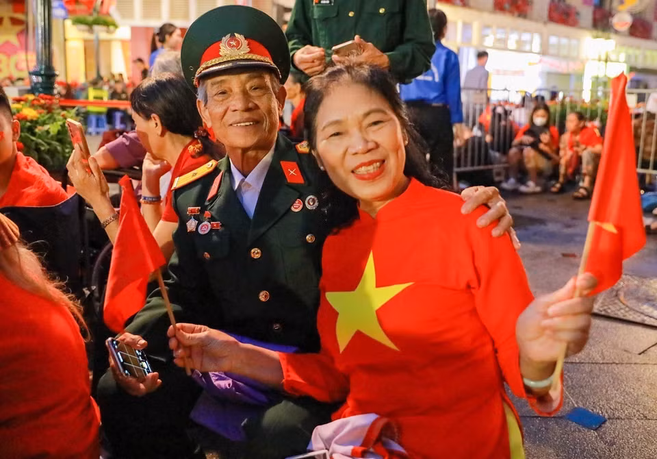 清晨，许多革命老兵携家人早早抵达行牌街，准备观看A80总彩排。图自越通社