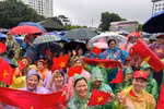 在大雨中，首都河内的市民无惧恶劣天气，耐心守候，只为即将登场的武装力量方阵加油助威。图自越通社。