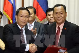 越南通讯社社长阮德利与老挝政治局委员、政府副总理潘坎•维帕万 