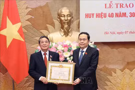 越南国会主席陈青敏向越共中央委员、国会党组委员、国会副主席阮德海同志授予40年党龄纪念章。图自越通社
