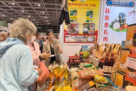 客户在中国香港举行的亚洲素食展上参观越南企业的产品。图自越通社