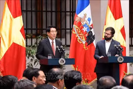 越南国家主席梁强同智利总统博里奇共同会见记者。图自越通社