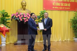 越共中央政治局委员、中央组织部部长范明政向张光义颁发​任命书。