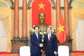 越南国家主席陈大光（右）会见新华社社长蔡名照。（图片来源：越通社）