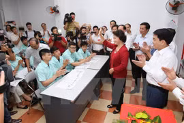 阮氏金银主席往河内市东英县金钟乡工人住宅区8号投票站进行检查（图片来源：越通社）